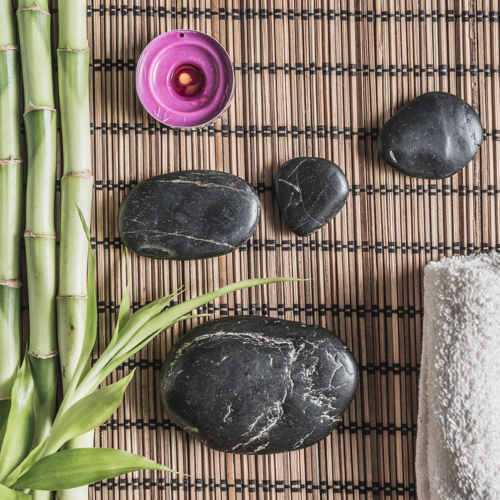 Warm spa stones and candle for hot stone massage